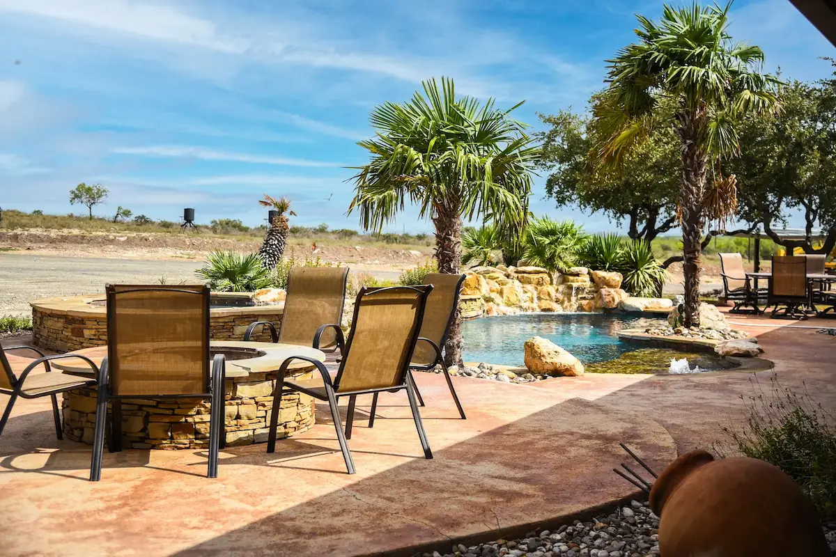 Outdoor fire pit next to a pool