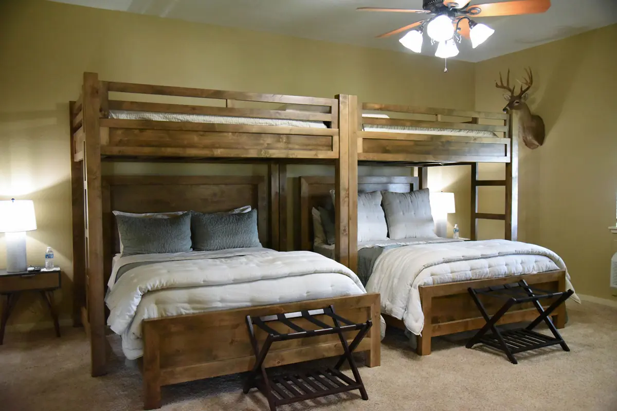 2 rustic styled bunk beds with fluffy comforters