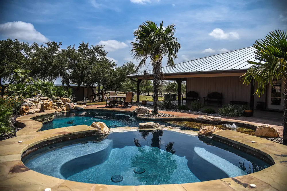 Luxurious pool with natural stone decorating the outside 
