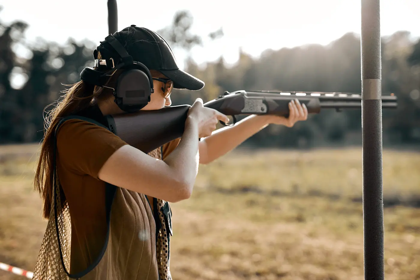 Girl holding a gun for skeet shooting