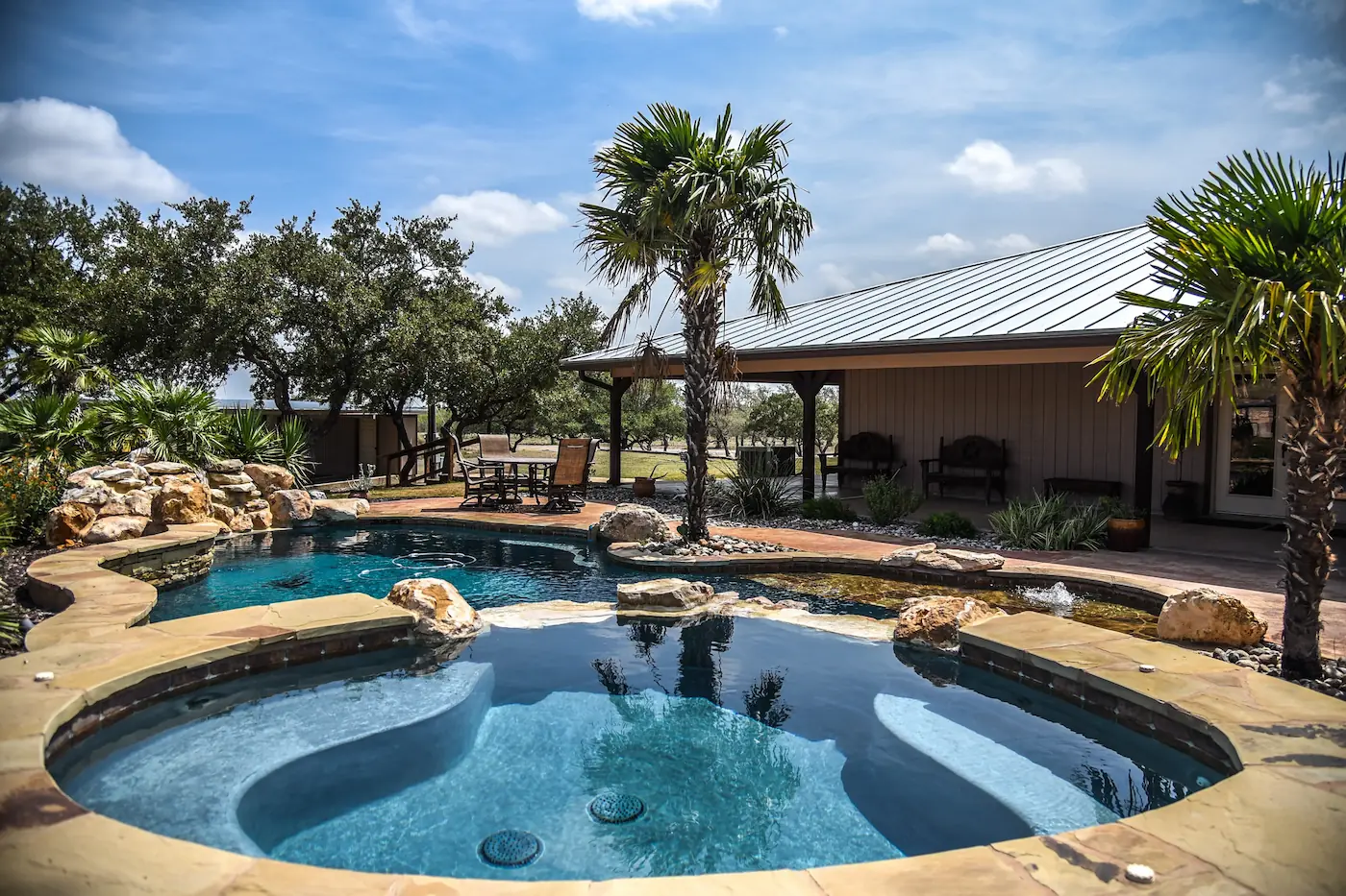 Swimming pool with palm trees around it