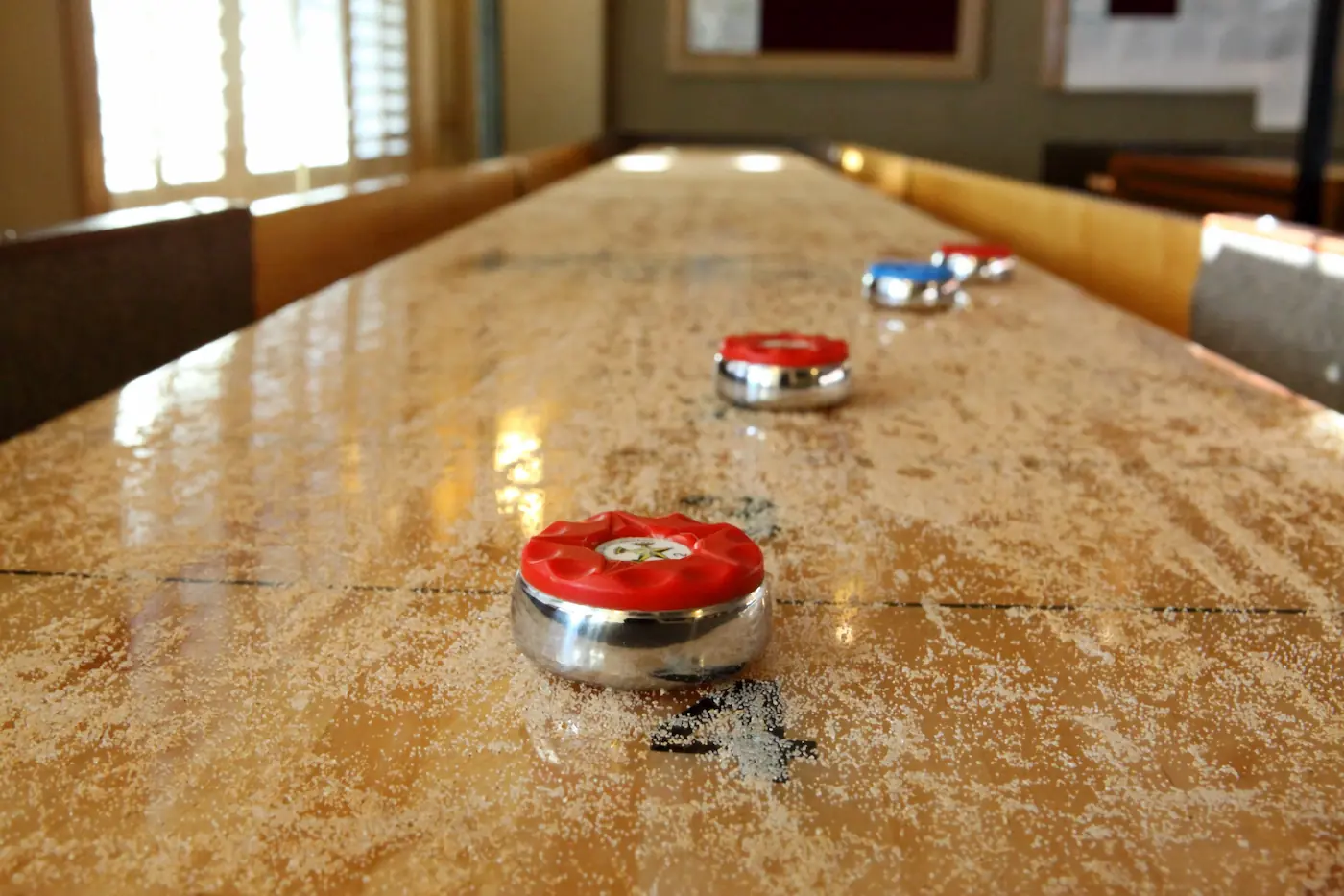 Shuffleboard pucks on a table.